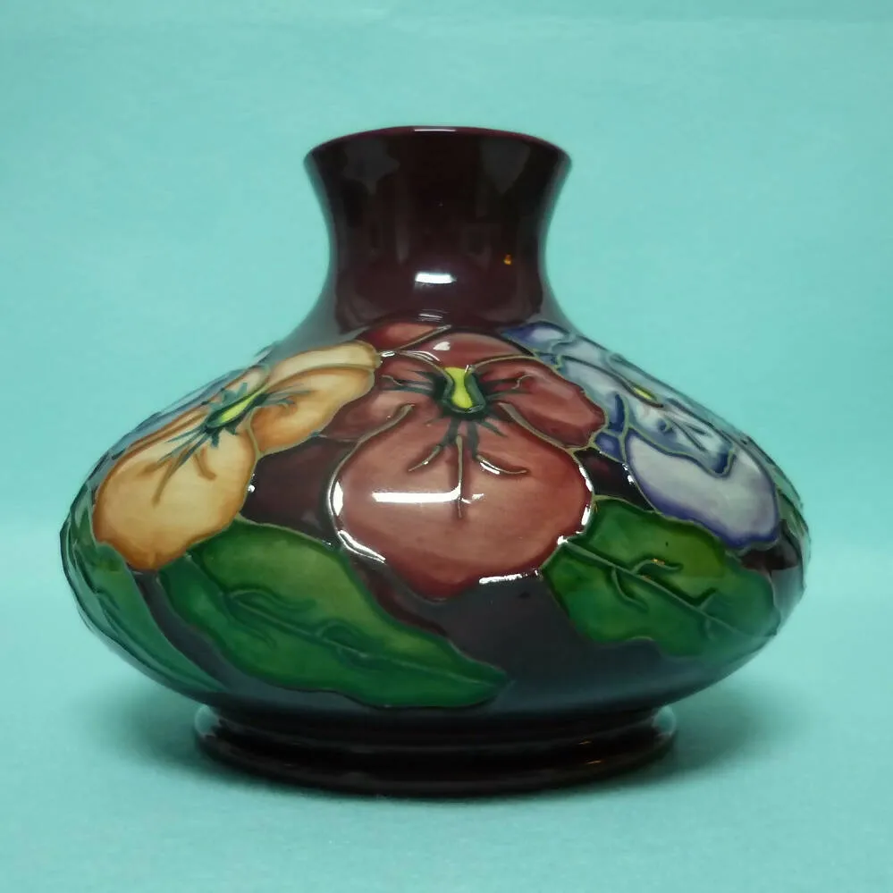 A Moorcroft Squat Vase (Dia 5.23") in the Pansy Design by Rachel Bishop