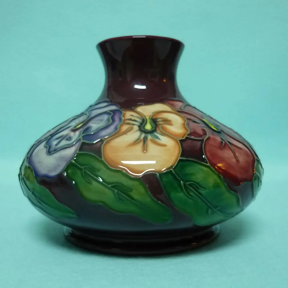 A Moorcroft Squat Vase (Dia 5.23") in the Pansy Design by Rachel Bishop